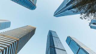skyscaper buildings with blue skies in the background